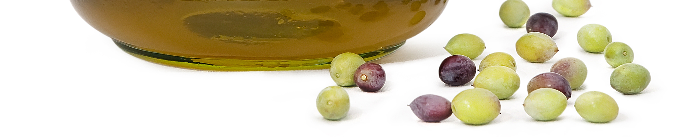 Olive oil and multi-coloured olive fruits scattered